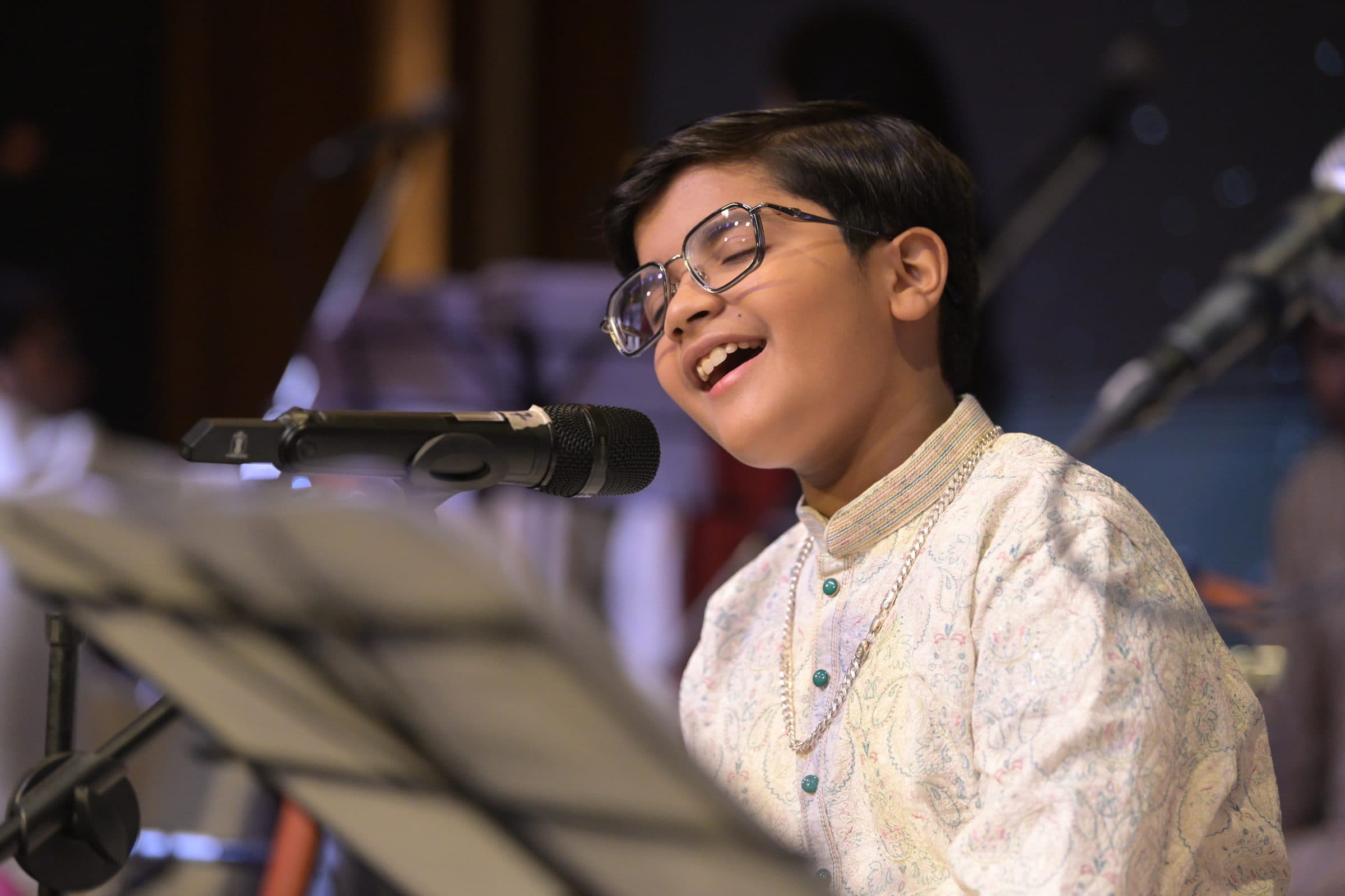 Adhyatma Sharma singing with passion